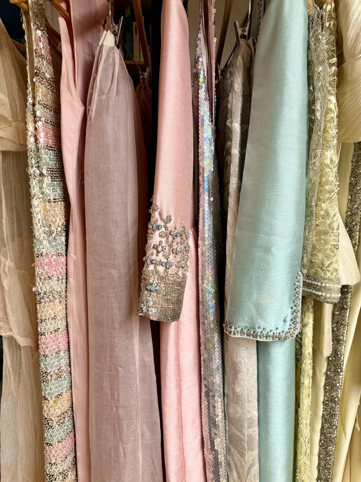 A rack of pastel vintage eveningwear &mdash; beaded, sequined, silk chiffon.