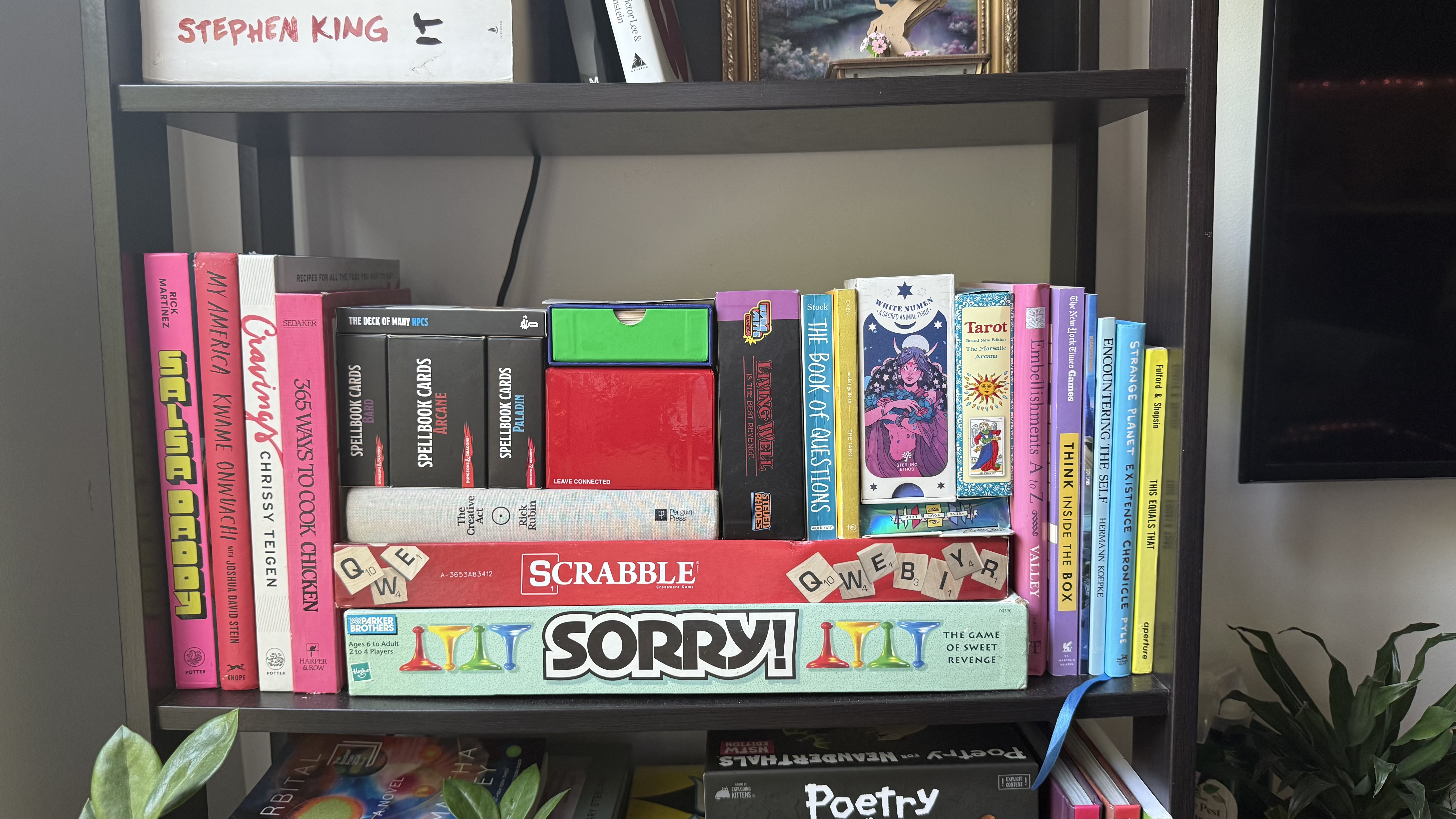 A shelf at D&rsquo;LOURDES&rsquo; home with books and objects arranged like Tetris pieces.