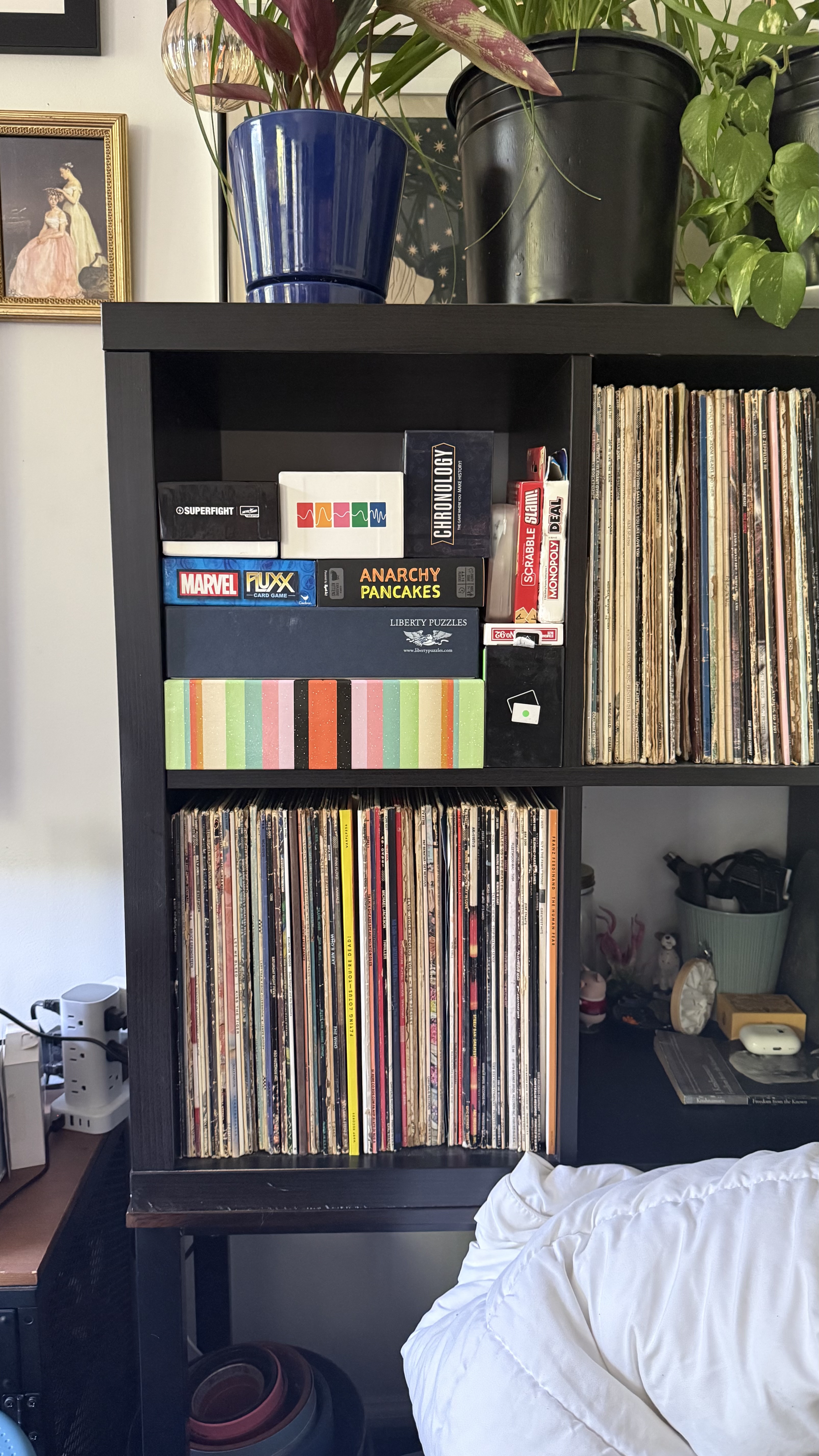 D&rsquo;LOURDES&rsquo; Tetris-style shelving &mdash; books and games turned to fit every available space.
