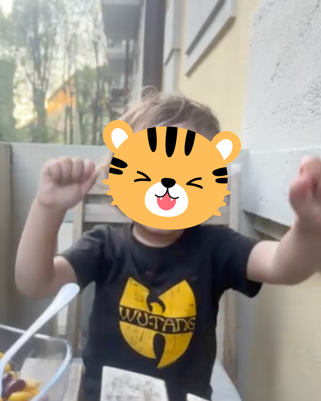 Pamala's friend's kid wearing a Wu-Tang Clan T-shirt.