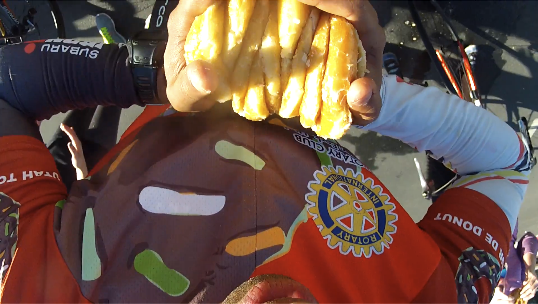 Yasir Salem compressing a stack of donuts before eating.